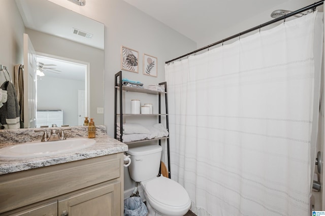 bathroom with vanity, toilet, and ceiling fan