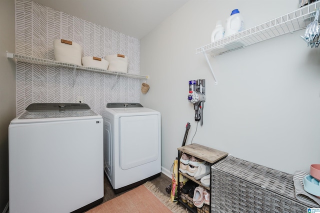 clothes washing area with dark hardwood / wood-style flooring and separate washer and dryer