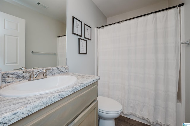 bathroom featuring hardwood / wood-style flooring, vanity, toilet, and a shower with shower curtain