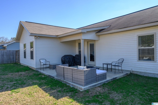 rear view of house with a lawn, outdoor lounge area, and a patio