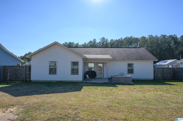 rear view of house featuring cooling unit, a patio area, and a yard