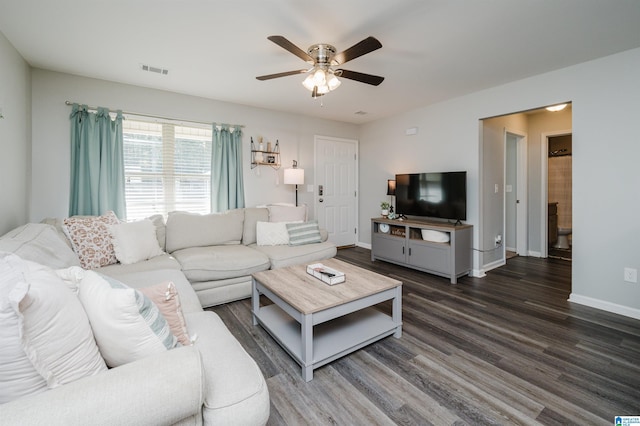 living room with dark hardwood / wood-style flooring and ceiling fan