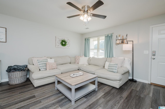 living room with ceiling fan and dark wood-type flooring