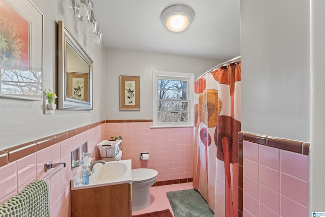 bathroom with tile patterned flooring, toilet, vanity, tile walls, and a shower with shower curtain