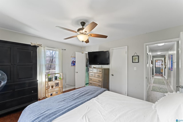 bedroom with ceiling fan and dark hardwood / wood-style flooring