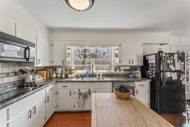 kitchen with black appliances, white cabinetry, and dark wood-type flooring