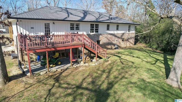 rear view of house with a lawn and a deck