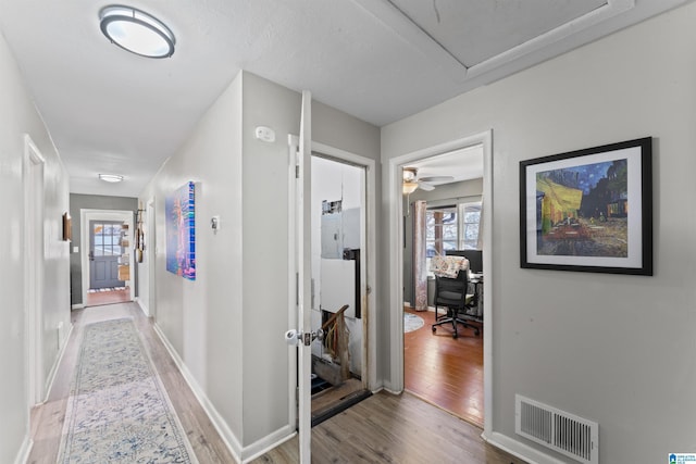 hall with hardwood / wood-style flooring