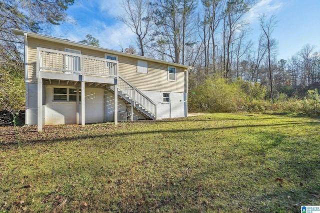 back of property featuring central air condition unit, a deck, and a lawn