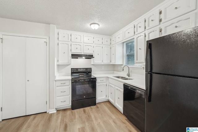 kitchen featuring black appliances, sink, light hardwood / wood-style flooring, a textured ceiling, and white cabinetry