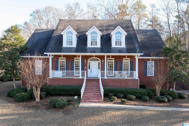 new england style home with covered porch