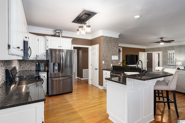 kitchen featuring white cabinets, sink, stainless steel appliances, and light hardwood / wood-style flooring