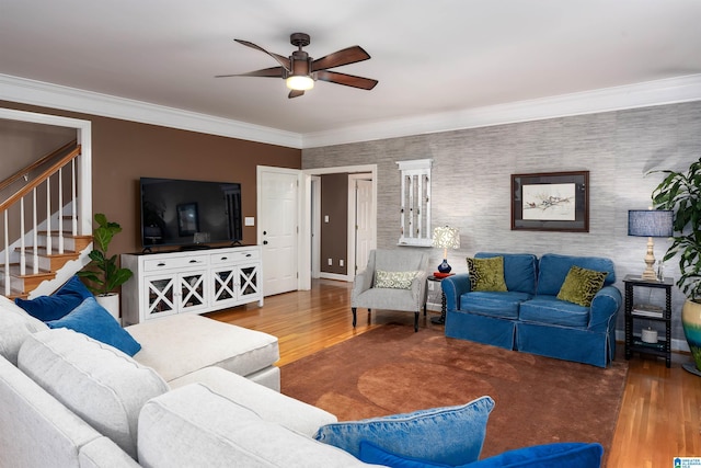 living room featuring hardwood / wood-style floors, ceiling fan, and ornamental molding