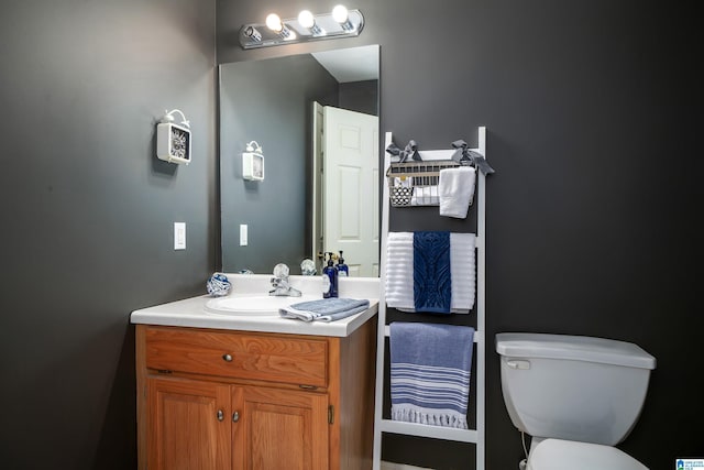 bathroom featuring vanity and toilet