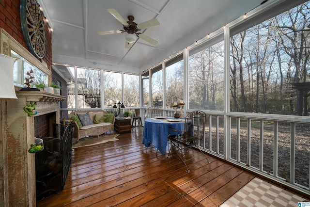 sunroom / solarium with a wealth of natural light and ceiling fan