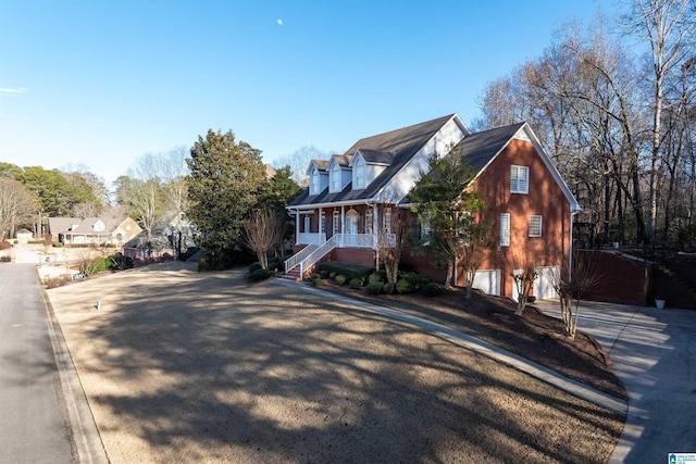 view of front facade featuring covered porch and a garage