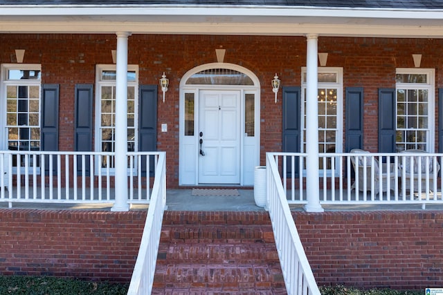 view of exterior entry featuring a porch