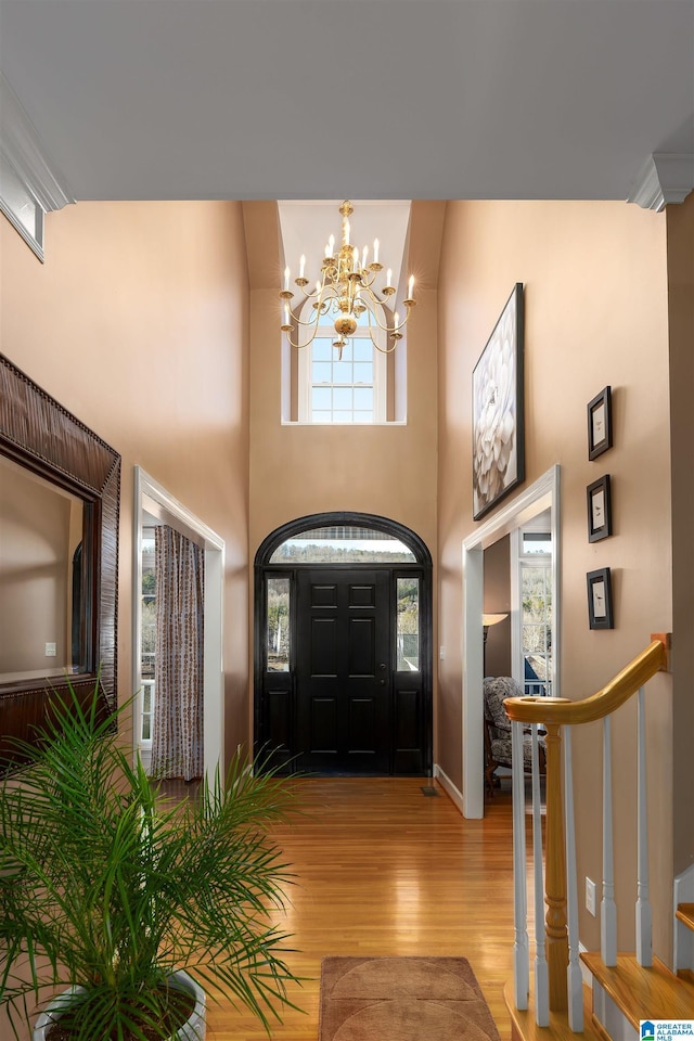 foyer entrance with a chandelier and light hardwood / wood-style floors