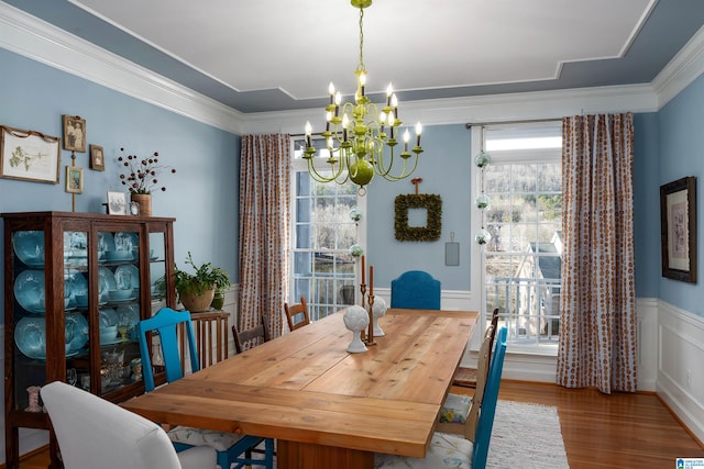 dining area featuring a notable chandelier, crown molding, and a wealth of natural light