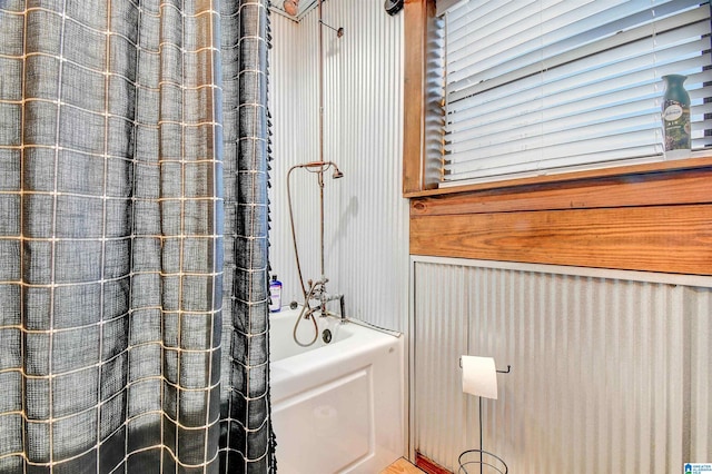 bathroom featuring shower / bath combo with shower curtain and plenty of natural light