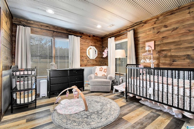 bedroom featuring wood walls, wood-type flooring, and wooden ceiling