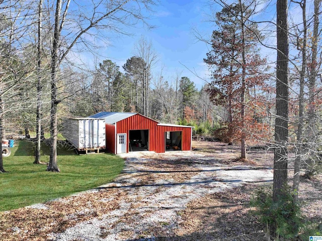 view of outbuilding featuring a lawn and a garage