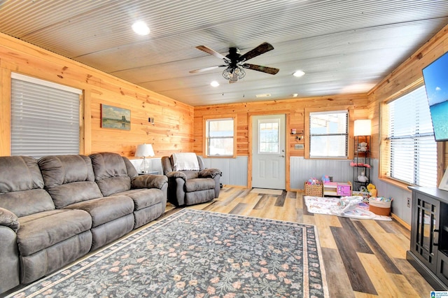 living room with light hardwood / wood-style floors, plenty of natural light, and ceiling fan