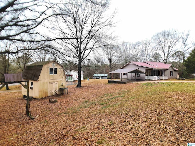 view of yard with a storage unit and covered porch