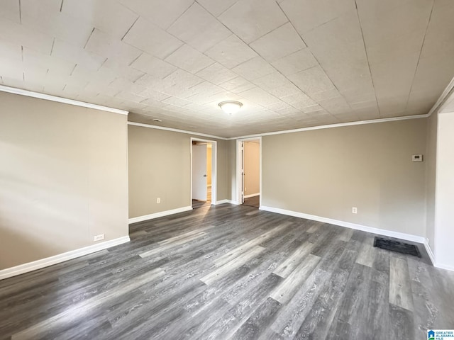 empty room featuring dark hardwood / wood-style flooring and crown molding