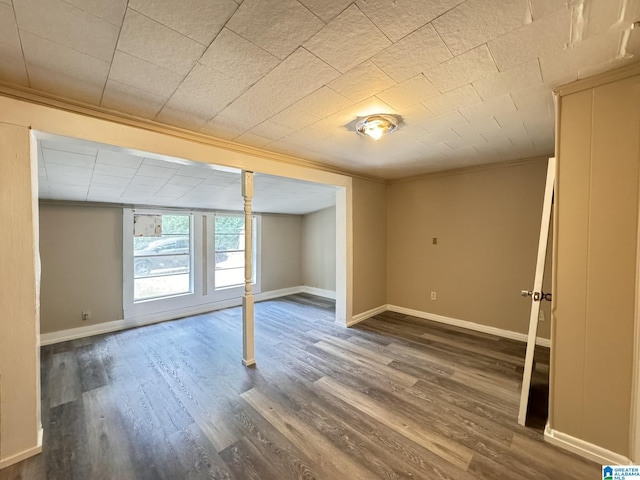 basement featuring dark hardwood / wood-style flooring and ornamental molding