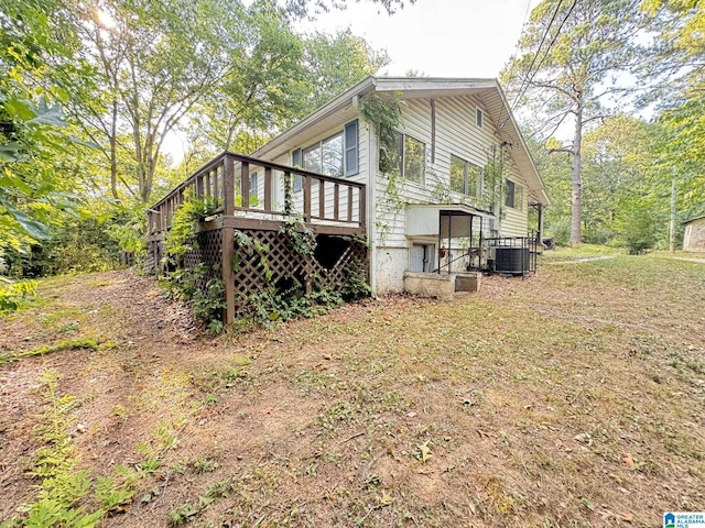 exterior space with a wooden deck and cooling unit