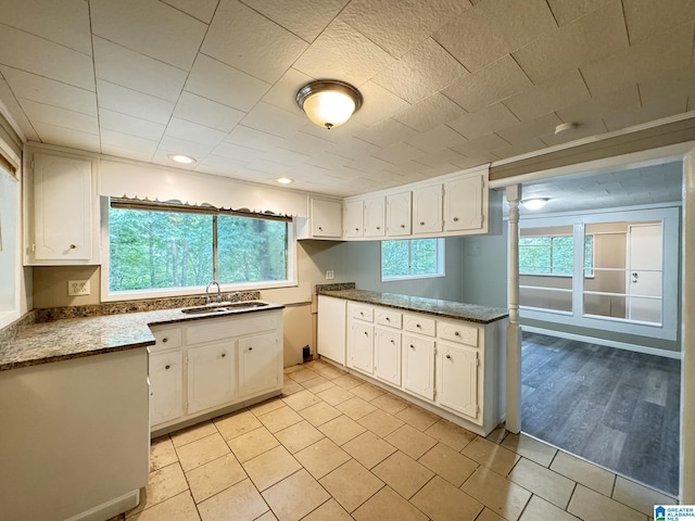 kitchen with white cabinetry, plenty of natural light, and sink