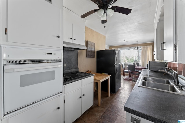 kitchen featuring ceiling fan, white cabinetry, black appliances, and sink