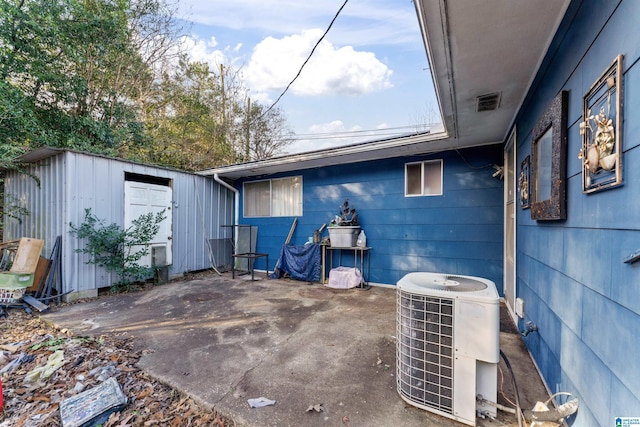 view of patio / terrace with a storage unit and cooling unit