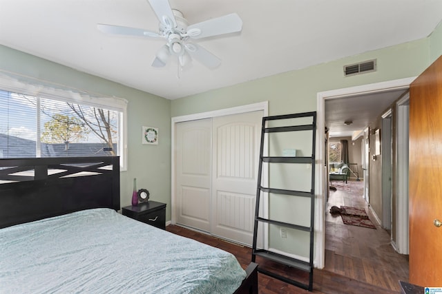 bedroom featuring dark hardwood / wood-style flooring, a closet, and ceiling fan