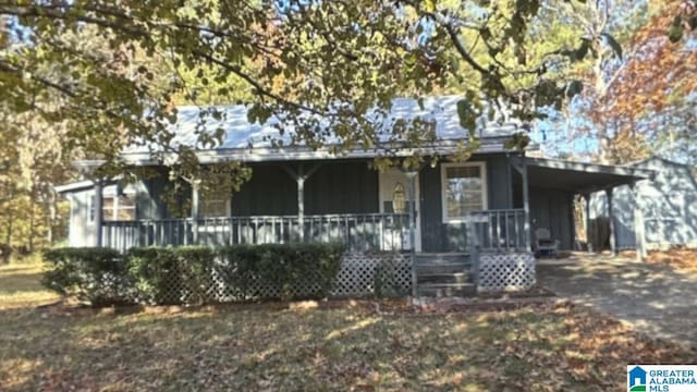 view of front of property featuring covered porch and a carport