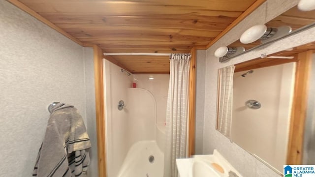 bathroom with curtained shower and wood ceiling