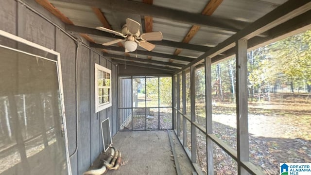 unfurnished sunroom featuring ceiling fan and lofted ceiling