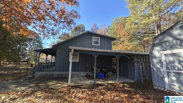 back of property featuring covered porch