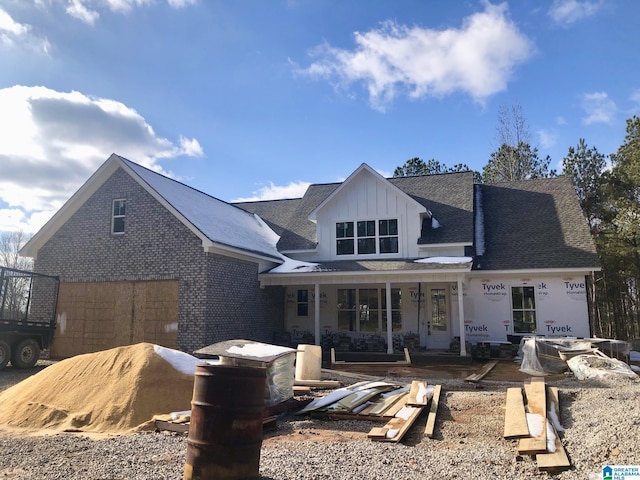 back of house featuring covered porch