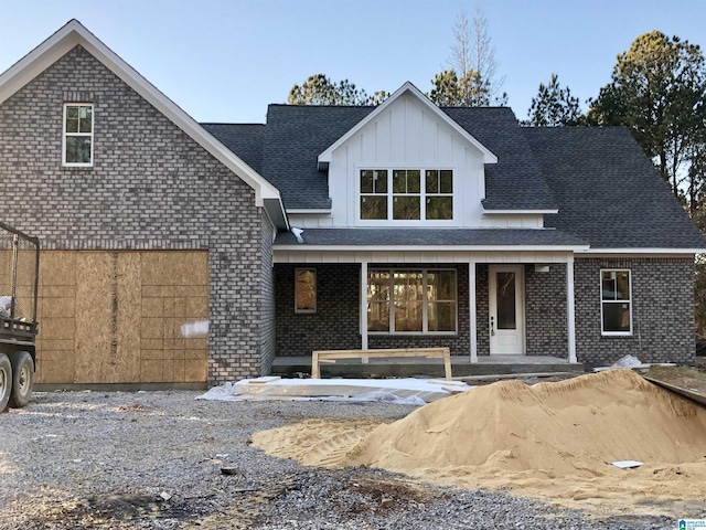 rear view of property with a porch