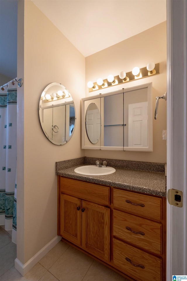 bathroom with a shower with shower curtain, vanity, and tile patterned floors