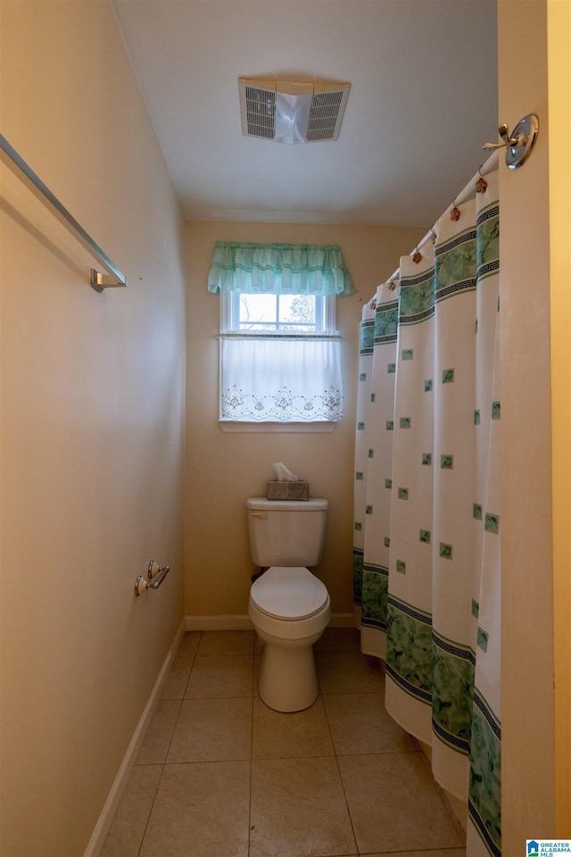 bathroom with tile patterned flooring and toilet