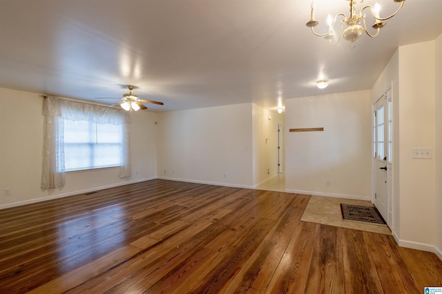 interior space with ceiling fan with notable chandelier and dark wood-type flooring