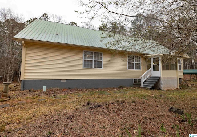 rear view of property with a sunroom