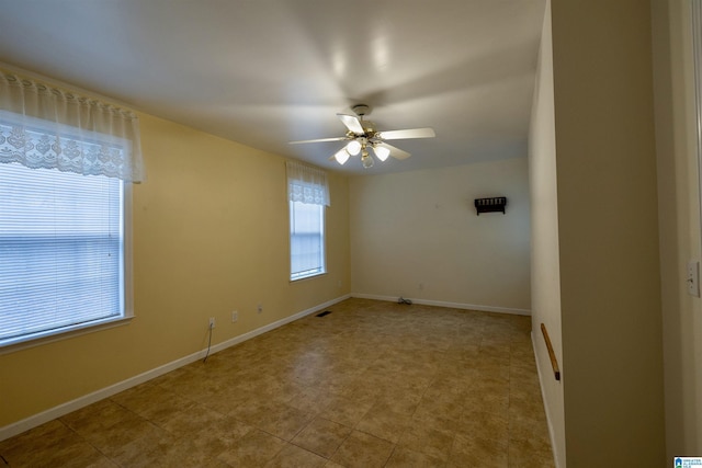 unfurnished room with plenty of natural light and ceiling fan