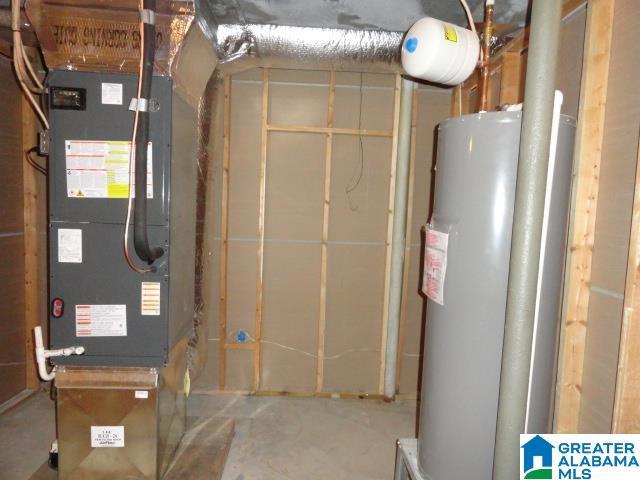 utility room with heating unit and water heater