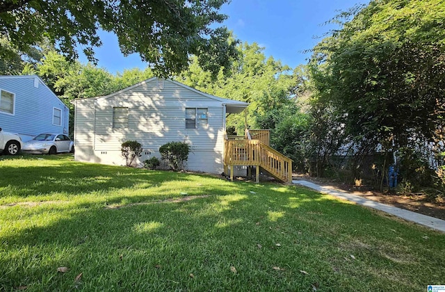 view of side of home with a yard