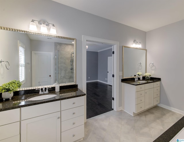 bathroom with tile patterned flooring, vanity, and walk in shower