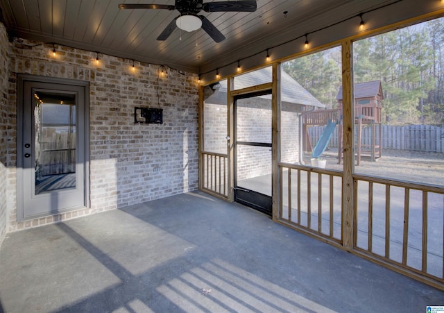 sunroom with ceiling fan and wooden ceiling